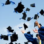 Graduates celebrate by throwing caps